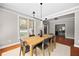 Dining room featuring a long wooden table with seating for six and a modern light fixture at 2742 Oak Village Trl, Decatur, GA 30032
