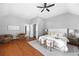 Bright main bedroom featuring hardwood floors, neutral paint, and a ceiling fan at 2742 Oak Village Trl, Decatur, GA 30032