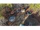 Expansive view of the property with wooded landscape, fire pit, storage shed, and trampoline for outdoor enjoyment at 4558 Bronte Ln, Douglasville, GA 30135