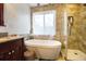 Bathroom featuring a freestanding tub and separate shower at 4558 Bronte Ln, Douglasville, GA 30135