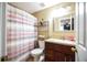 Bathroom has a combination shower and tub, granite vanity, and decorative mirror at 4558 Bronte Ln, Douglasville, GA 30135