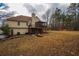 Large backyard features a house with a deck, a screened porch, and a stone patio at 4558 Bronte Ln, Douglasville, GA 30135