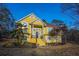 Stunning two-story home with vibrant yellow exterior and well-maintained landscaping at 4558 Bronte Ln, Douglasville, GA 30135