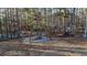 Wood burning fire pit area with swing seating provides a relaxing outdoor entertainment area at 4558 Bronte Ln, Douglasville, GA 30135