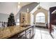 Kitchen island with granite countertop, stylish pendant lights, and barstool seating, adjacent to the breakfast area at 4558 Bronte Ln, Douglasville, GA 30135