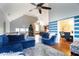 Bright living room with vaulted ceilings, plush blue furniture, and an adjacent dining area at 4558 Bronte Ln, Douglasville, GA 30135