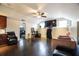 Spacious living room features dark wood floors, a ceiling fan, and a large TV at 4558 Bronte Ln, Douglasville, GA 30135