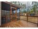 Screened porch leads to a wooden deck and backyard at 4558 Bronte Ln, Douglasville, GA 30135