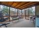 Relaxing screened porch has wicker furniture and a view of the wooded backyard at 4558 Bronte Ln, Douglasville, GA 30135