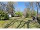 Large backyard showcasing mature trees, a stone fireplace, and a shed for extra storage at 595 Ridgecrest Ne Rd, Atlanta, GA 30307