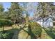 Landscaped backyard with a stone walkway, mature trees, and a shed, ideal for outdoor living and gardening at 595 Ridgecrest Ne Rd, Atlanta, GA 30307