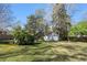 Large grassy backyard with mature trees and an outbuilding shed, perfect for outdoor activities and storage at 595 Ridgecrest Ne Rd, Atlanta, GA 30307