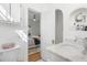 Bathroom with a marble vanity top and open door leading to a bedroom with hardwood floors at 595 Ridgecrest Ne Rd, Atlanta, GA 30307