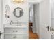 Charming bathroom featuring white vanity with marble countertop, decorative mirror, and gold hardware at 595 Ridgecrest Ne Rd, Atlanta, GA 30307