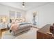 Well-lit bedroom showcasing a plush bed, wooden dresser, and direct access to outdoor patio at 595 Ridgecrest Ne Rd, Atlanta, GA 30307