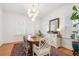 Bright dining room with shuttered windows, a modern chandelier, and stylish decor at 595 Ridgecrest Ne Rd, Atlanta, GA 30307