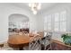 Open-concept dining area with a wooden table and arched doorway leading to the living room at 595 Ridgecrest Ne Rd, Atlanta, GA 30307