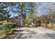 Wide driveway leading to the rear of a brick home, offering parking and access to the private backyard retreat at 595 Ridgecrest Ne Rd, Atlanta, GA 30307