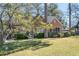 Beautiful brick home with mature trees, green lawn and landscaping, and a screened-in porch at 595 Ridgecrest Ne Rd, Atlanta, GA 30307