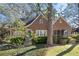 Charming brick home with a blue door, stone archway and a screened-in porch nestled among mature trees at 595 Ridgecrest Ne Rd, Atlanta, GA 30307