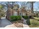 Charming brick home featuring a blue door, lush landscaping, and a stone walkway to the front entrance at 595 Ridgecrest Ne Rd, Atlanta, GA 30307