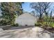 A two-door garage with a concrete driveway surrounded by trees, bushes, and partial sunshine at 595 Ridgecrest Ne Rd, Atlanta, GA 30307