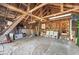 Interior view of garage with wood ceiling, a concrete floor with a tarp, chairs, and shelves at 595 Ridgecrest Ne Rd, Atlanta, GA 30307