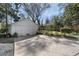 Exterior side view of a two-door garage with a concrete driveway, bushes, and partial sunshine at 595 Ridgecrest Ne Rd, Atlanta, GA 30307