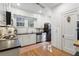 Classic white kitchen featuring stainless steel appliances and hardwood floors at 595 Ridgecrest Ne Rd, Atlanta, GA 30307
