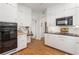 Bright kitchen with white cabinetry, gas range, and hardwood floors at 595 Ridgecrest Ne Rd, Atlanta, GA 30307