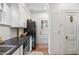 Bright kitchen features white cabinets, black appliances, and hardwood floors at 595 Ridgecrest Ne Rd, Atlanta, GA 30307