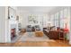 Bright and airy living room featuring a fireplace, hardwood floors, and plantation shutters at 595 Ridgecrest Ne Rd, Atlanta, GA 30307