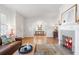 Inviting living room featuring a cozy fireplace and hardwood floors, seamlessly flowing into the dining area at 595 Ridgecrest Ne Rd, Atlanta, GA 30307