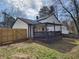 Backyard with a wood fence, lawn, and covered patio at 11250 Bramshill Dr, Johns Creek, GA 30022