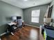 Bright home office with a well-lit desk area, featuring a window, modern equipment, and clean hardwood floors at 11250 Bramshill Dr, Johns Creek, GA 30022