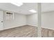 Finished basement with wood-look floors and natural light from a window at 2401 Westland Way, Acworth, GA 30102