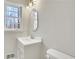 Bright bathroom features a modern vanity, oval mirror, and a window letting in natural light at 2401 Westland Way, Acworth, GA 30102