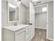 Bright bathroom featuring a white vanity with modern fixtures and an adjacent storage space at 2401 Westland Way, Acworth, GA 30102