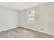 This bedroom features clean walls and new wood-look floors, plus a nice window view at 2401 Westland Way, Acworth, GA 30102
