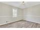 The bedroom features clean, neutral walls, wood-look floors, and a bright window view at 2401 Westland Way, Acworth, GA 30102