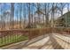 Expansive wooden deck with railings offers a relaxing space with a serene view of the wooded surroundings at 2401 Westland Way, Acworth, GA 30102