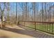 Wide deck offers a peaceful retreat with views of the surrounding greenery and the side of the home at 2401 Westland Way, Acworth, GA 30102