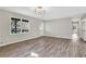 Spacious living room featuring wood-look floors, base molding and multiple windows at 2401 Westland Way, Acworth, GA 30102