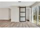 Bright living area with sliding glass doors to deck and unique sliding barn door at 2401 Westland Way, Acworth, GA 30102