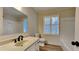 Bathroom with vanity and black faucet, white toilet and shower, and a window with shutters at 260 N Fayette Dr, Fayetteville, GA 30214
