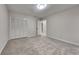 Bedroom featuring neutral carpeting and a closet with folding, shutter style doors at 260 N Fayette Dr, Fayetteville, GA 30214