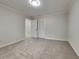 Bedroom featuring neutral carpeting and a closet with folding, shutter style doors at 260 N Fayette Dr, Fayetteville, GA 30214