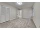Bedroom featuring neutral carpeting, a window, and a closet with folding, shutter style doors at 260 N Fayette Dr, Fayetteville, GA 30214