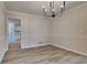 Bright dining room featuring stylish chandelier and wood flooring at 260 N Fayette Dr, Fayetteville, GA 30214