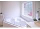 Bathroom features a corner tub and decorative window at 3533 Saddlebrook Dr, Loganville, GA 30052